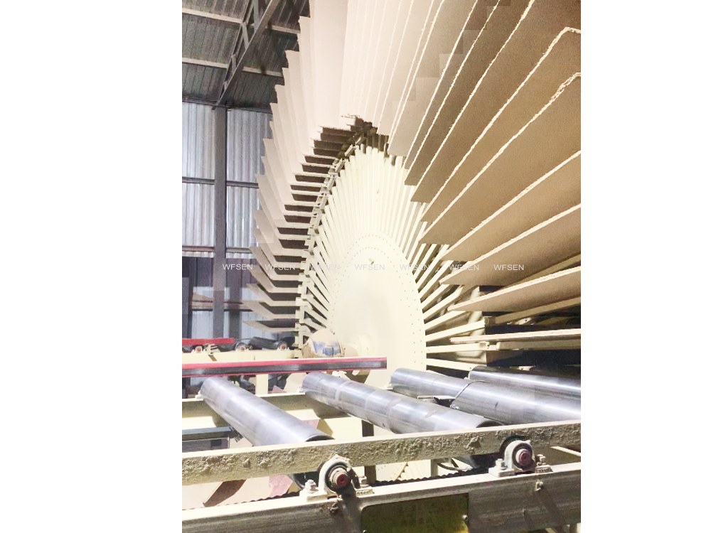 Panels stacked on a rotary curing rack after leaving the pressing stage